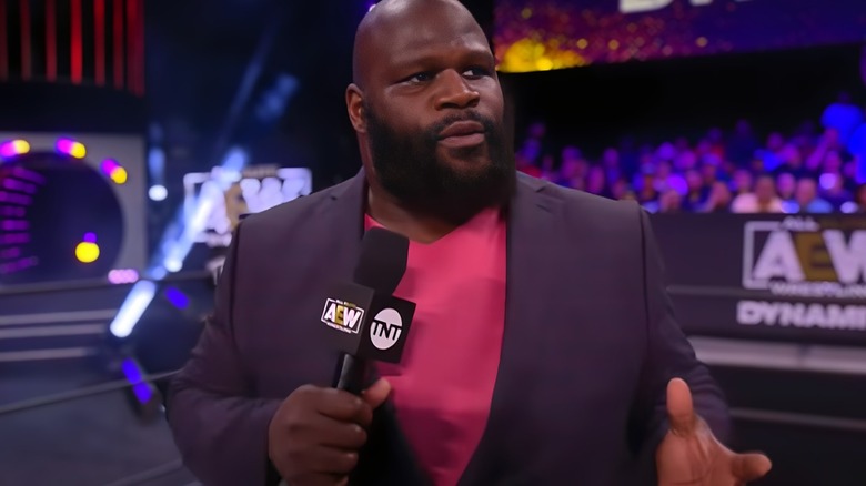 Mark Henry holding a mic