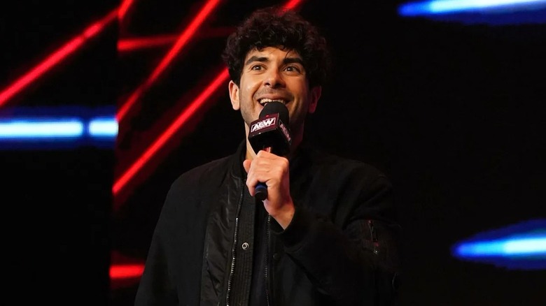 AEW President Tony Khan smiles on before giving an announcement on AEW programming