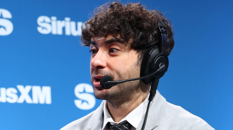 Tony Khan wearing a headset at a SiriusXM radio event