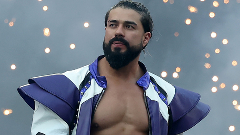 Andrade is wearing a black and white ring jacket