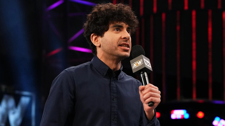 Tony Khan holding a mic