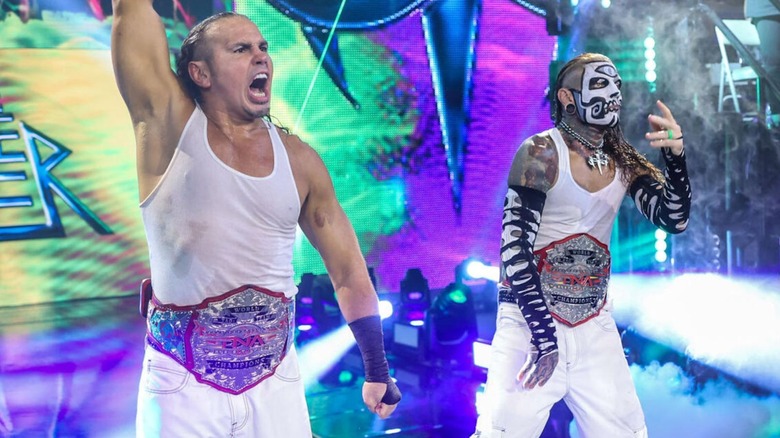 Matt and Jeff Hardy stand on the stage at the WWE Performance Center, wearing the TNA Tag Team Championships, during their appearance on 