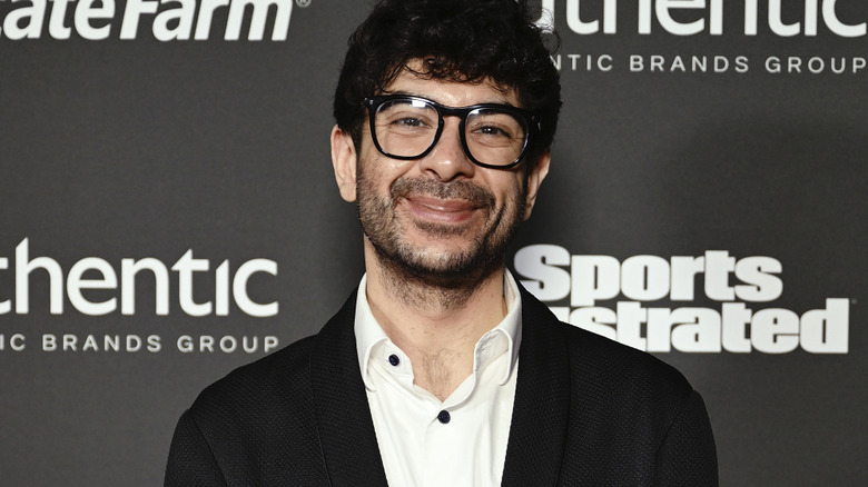 Tony Khan wearing glasses