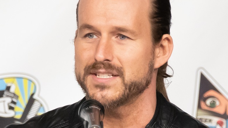 Adam Cole talking into microphone