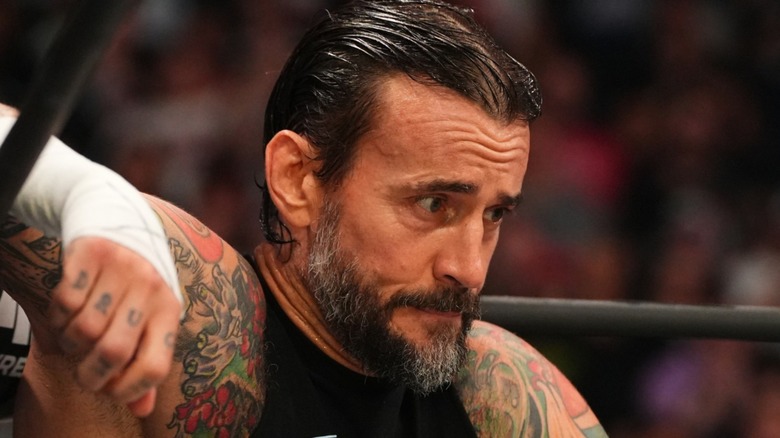 CM Punk sitting with concern on his face