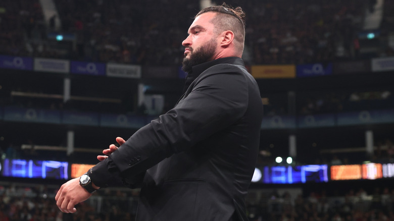 Wardlow adjusts his suit after attacking Swerve Strickland in the ring during his return at AEW x NJPW Forbidden Door.