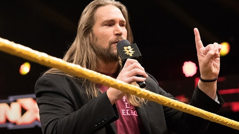 Chris Hero speaking into microphone