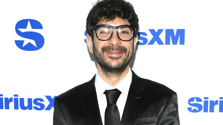 Tony Khan wearing glasses