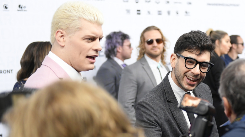 Cody Rhodes and Tony Khan together with Hangman Adam Page between them