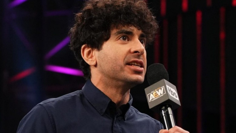 Tony Khan with a microphone in hand