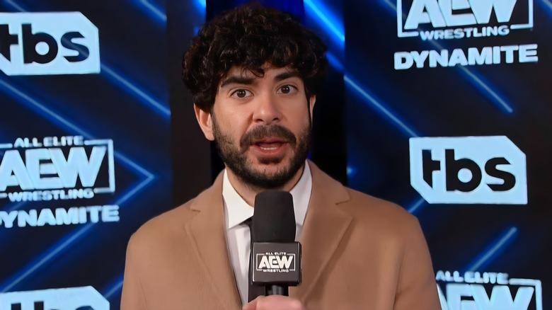Tony Khan holding a mic