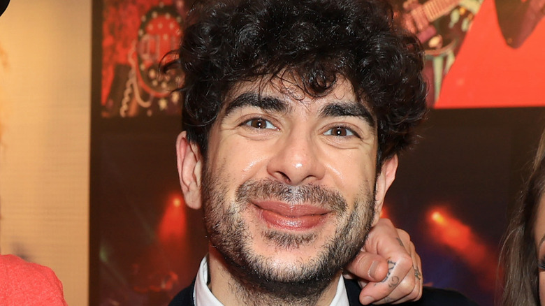 AEW CEO Tony Khan smiles