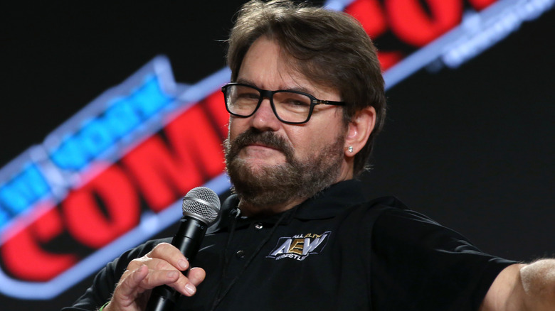 Tony Schiavone holding a microphone