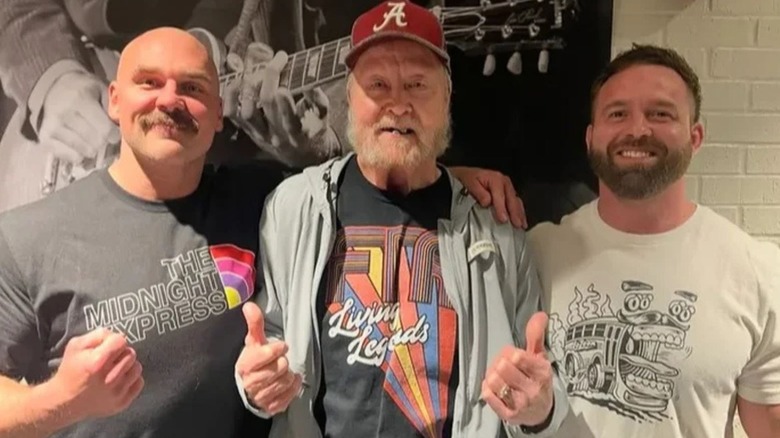 Dax Harwood and Cash Wheeler pose smiling alongside Dennis Condrey in a photo posted to a GoFundMe account following his passing.