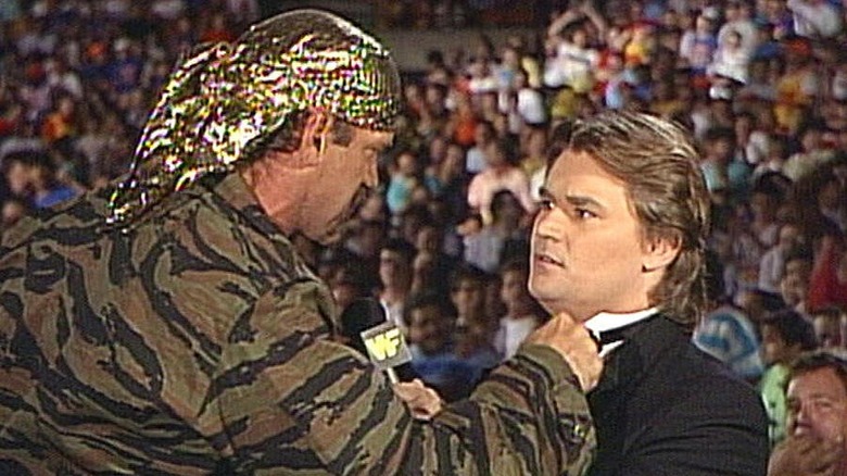 Jesse Ventura and Tony Schiavone during an in-ring interview segment.