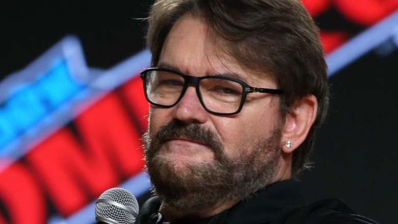 Tony Schiavone has a microphone