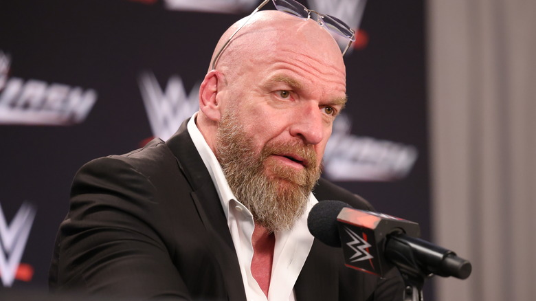 Triple H wearing glasses on his head