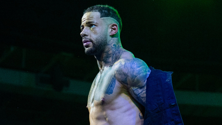 Trey Miguel takes his jacket off