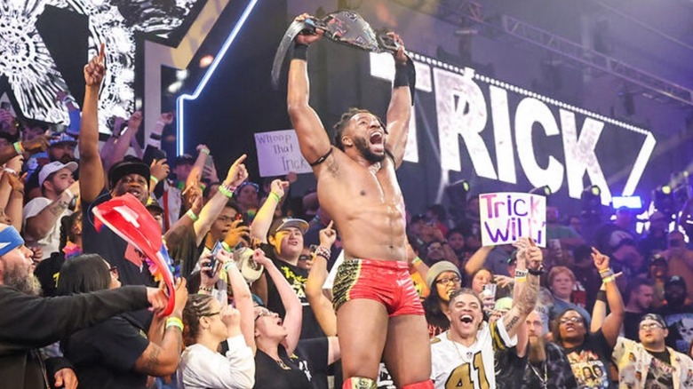 "WWE NXT's" Trick Williams holds his newly-won NXT Championship high with the fans behind him at the WWE Performance Center.