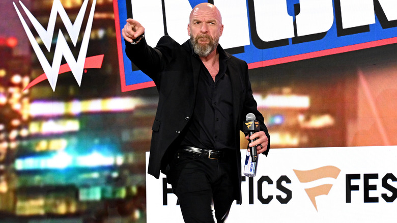Triple H pointing on stage