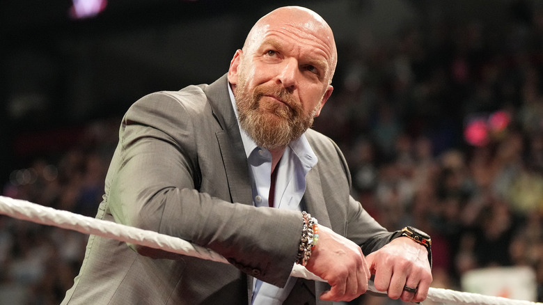 Triple H leaning against the ring ropes