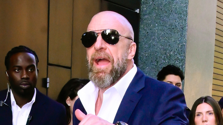 Triple H being told he has to take a photo with Danhausen