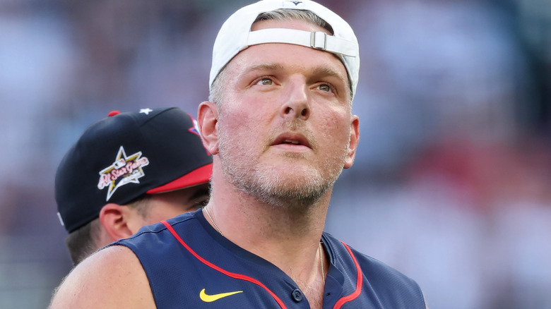 Pat McAfee wearing a white baseball hat