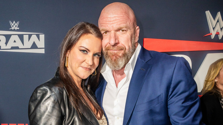 Stephanie McMahon and Triple H posing on the red carpet