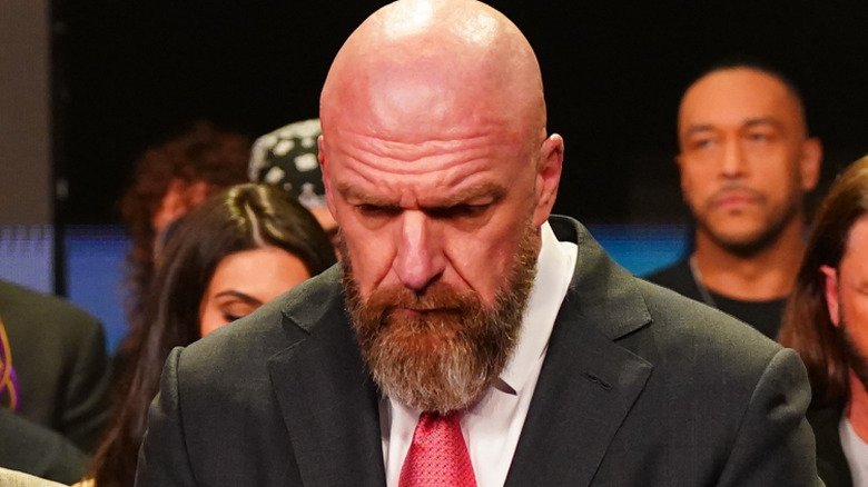triple h bowing his head at Hogan tribute