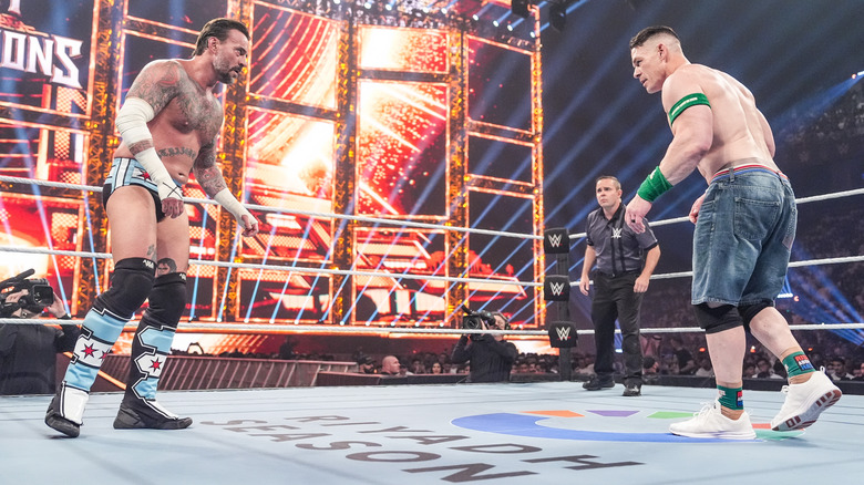 CM Punk and John Cena squaring up in the ring