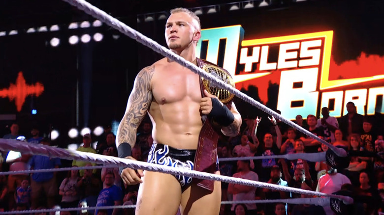 Myles Borne stands with the "NXT" North American Championship.