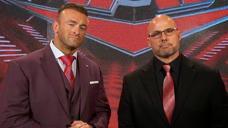 "WWE SmackDown" GM Nick Aldis and "WWE Raw" GM Adam Pearce posing.