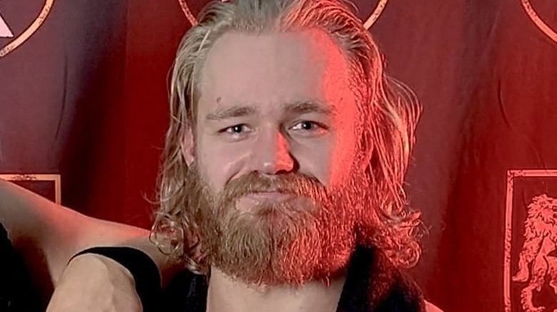 Tyler Bate smiling with a beard