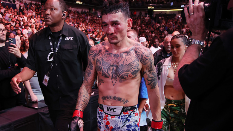 Max Holloway walks out of the venue