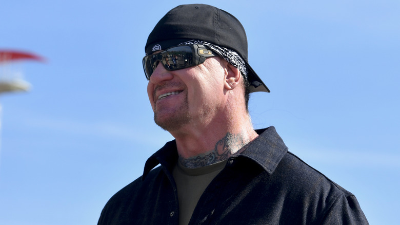 The Undertaker posse for a photo prior to his pace car practice ride for the NASCAR Cup Series