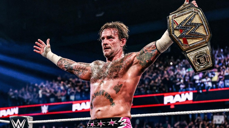 CM Punk holding the WWE title