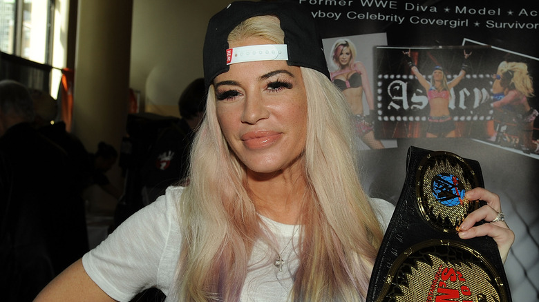 Ashley Massaro holding a championship belt