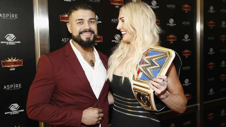 Andrade El Idolo posing with Charlotte Flair
