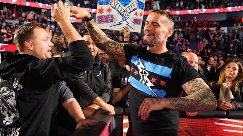 CM Punk slapping hands with fans