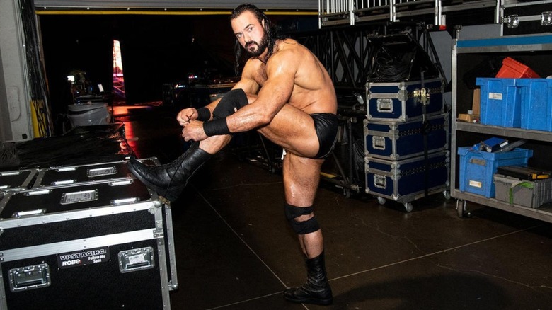 Drew McIntyre laces his boots backstage before a match.