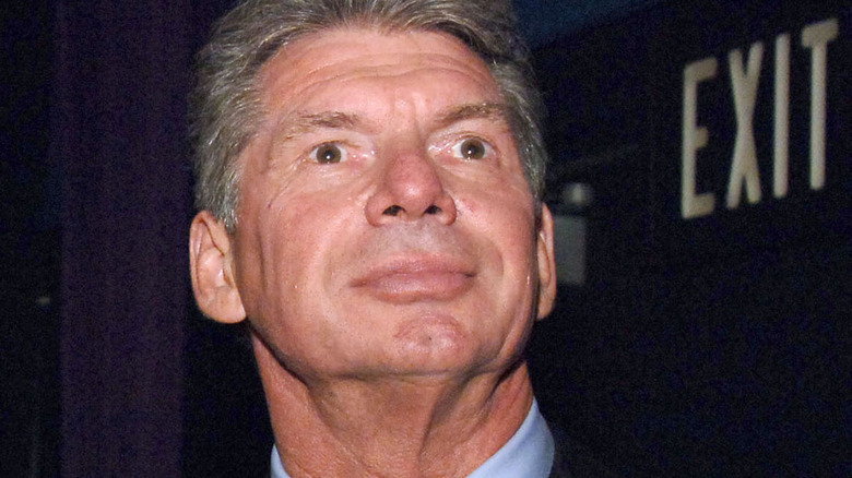 Vince McMahon next to an "Exit" sign