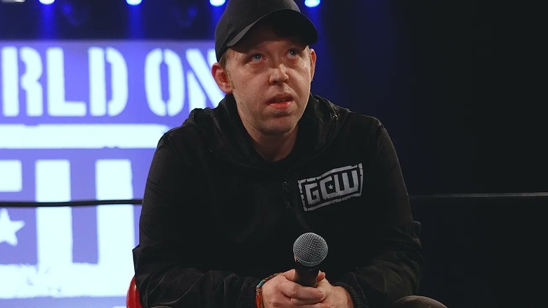 Brett Lauderdale looks up as he speaks in a GCW ring.