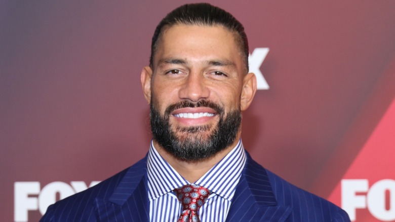 Roman Reigns in a navy pinstripe suit