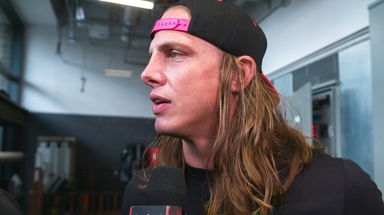 Matt Riddle talking into microphone