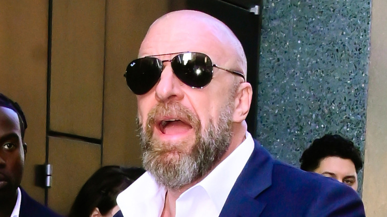 Triple H wearing shades to block out the sun