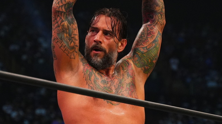 CM Punk lifts his arms