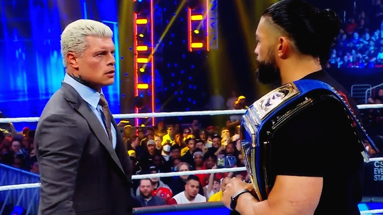 Cody Rhodes facing off with Roman Reigns on SmackDown