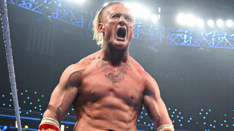 Ilja Dragunov flexes his muscles and yells