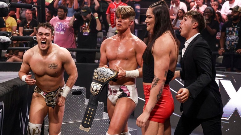 NXT Tag Team Champions Ricky Smokes and Brad Baylor stand ringside with Myka Lockwood and Jackson Drake after a victory on 