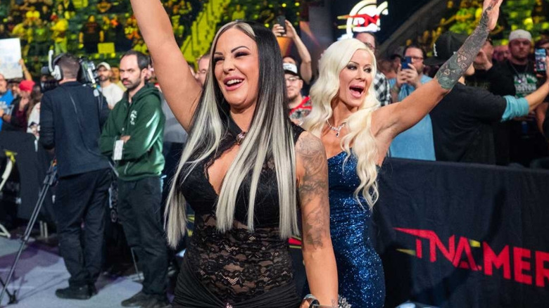 Velvet Sky and Angelina Love are waving to the crowd